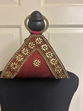 Purse reddish burnt with gold bead design, Very unique design with a gold handle